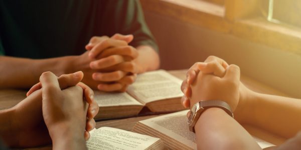 Christians join a group of cells that come together to pray and seek the blessings of God. with bible and share the gospel with copy space near the window sill in the morning